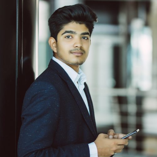 indian business man reading or using smart phone
